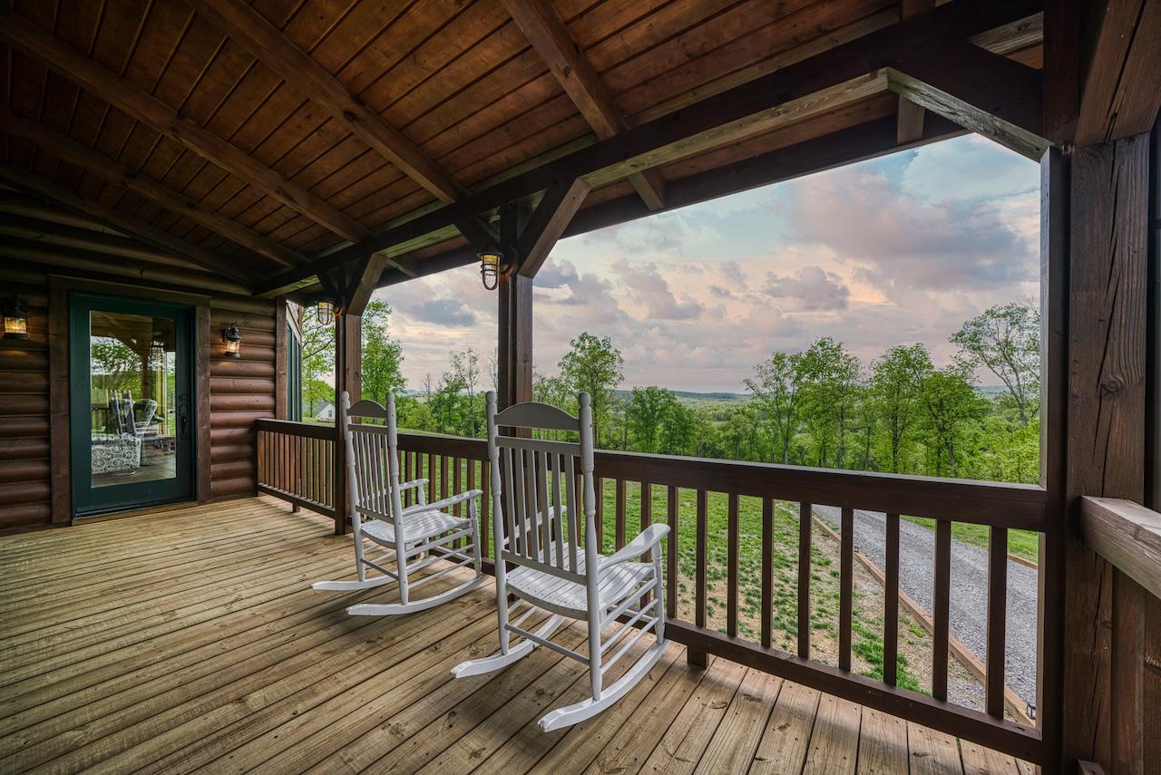 Photo of porch with rocking chairs and planters on deck railings