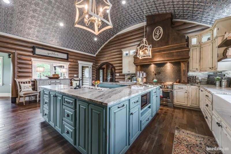 country kitchen with round log wall and curved ceiling