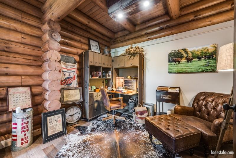 photo of home office tucked into exposed wood giant round log walls